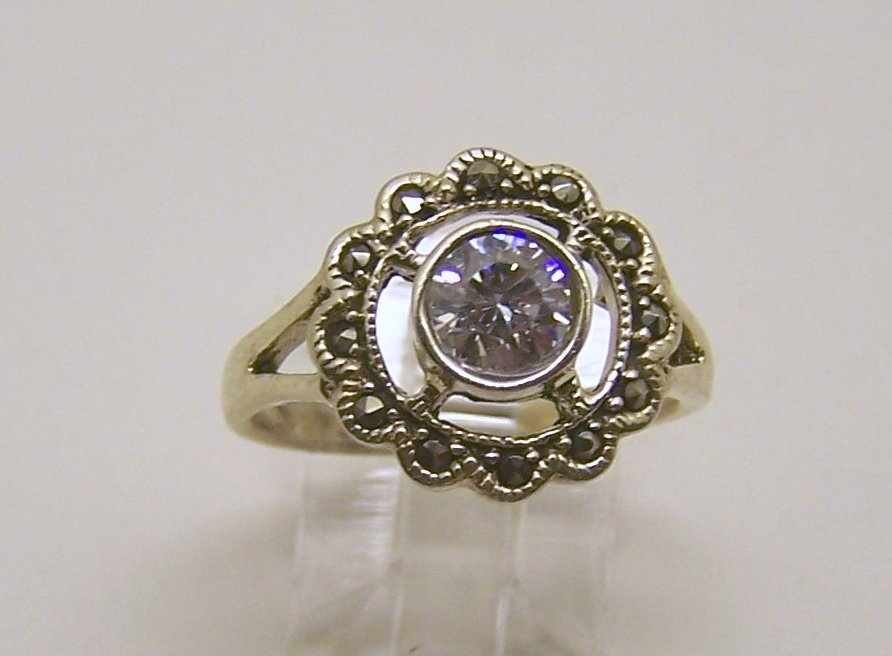 sterling silver cz marcasite ring: top of the ring measures 9/16" wide, crafted with 6mm cz, size 7 3/4, weights 4.4 grams, in good condition