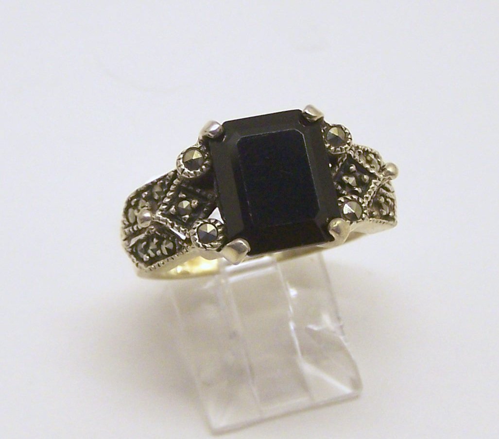 NF sterling silver onyx marcasite ring: top of the ring measures 7/16" wide, size 7 3/4, weights 6.8 grams, in good condition