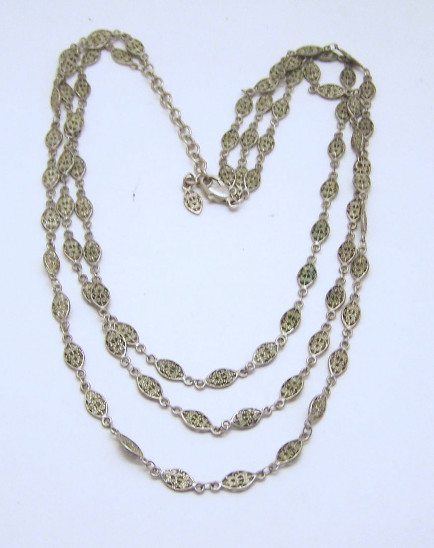 silver tone necklace: measures 18" long, in good condition
