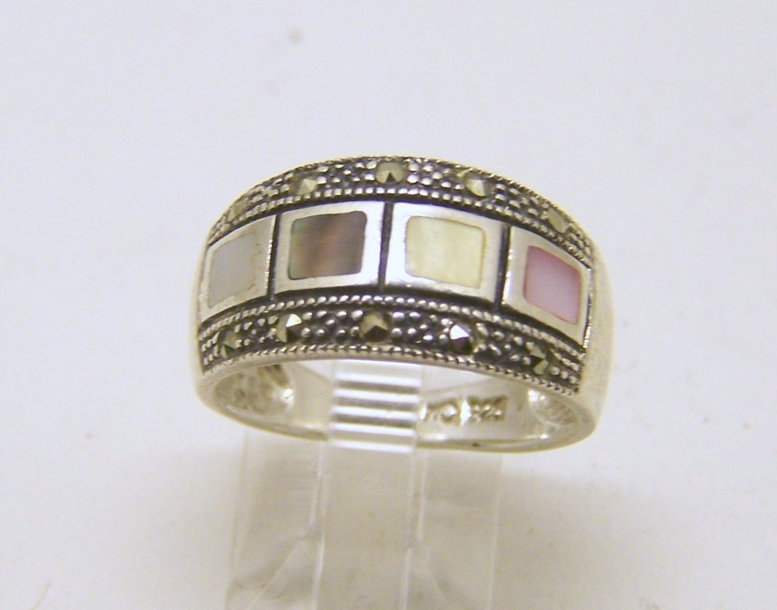 MO sterling silver mother of pearl marcasite ring: top of the ring measures 7/16" wide, size 8, weights 4.3 grams, in good condition