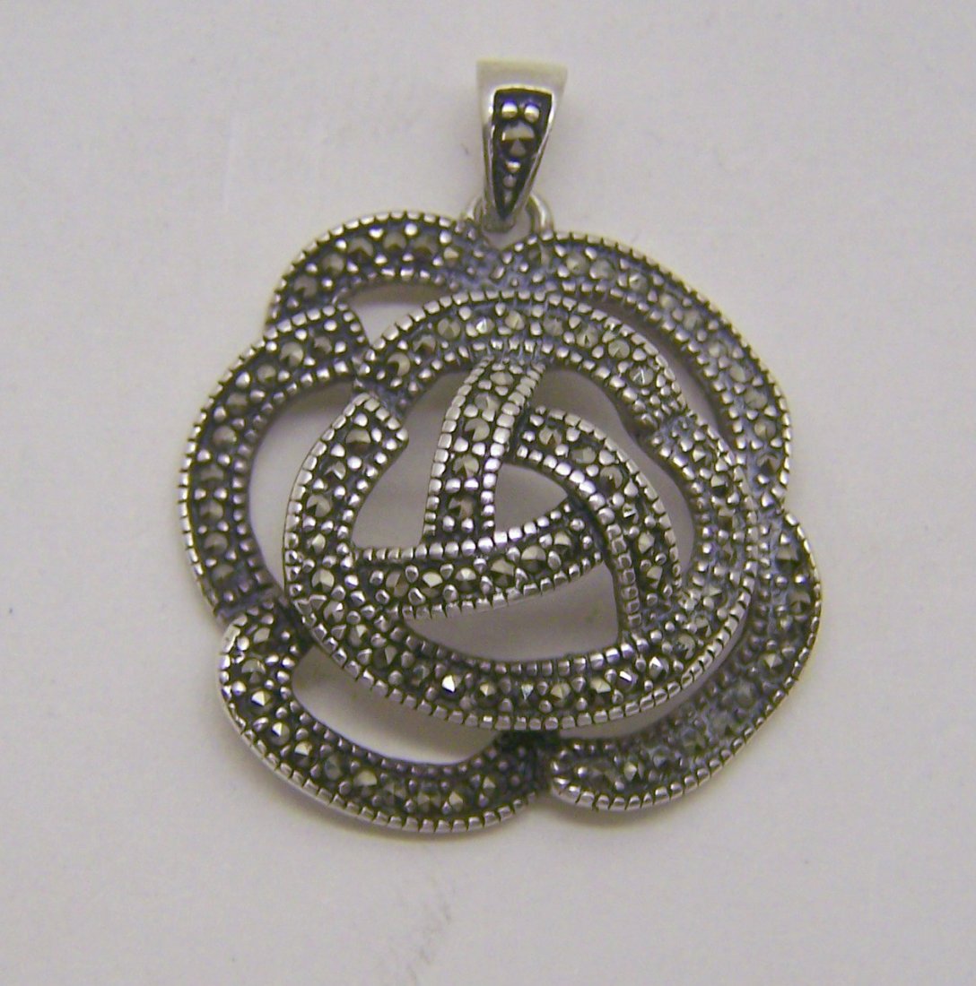 sterling silver marcasite pendant: measures 1 1/4" long by 1" wide, weights 6 grams, in good condition