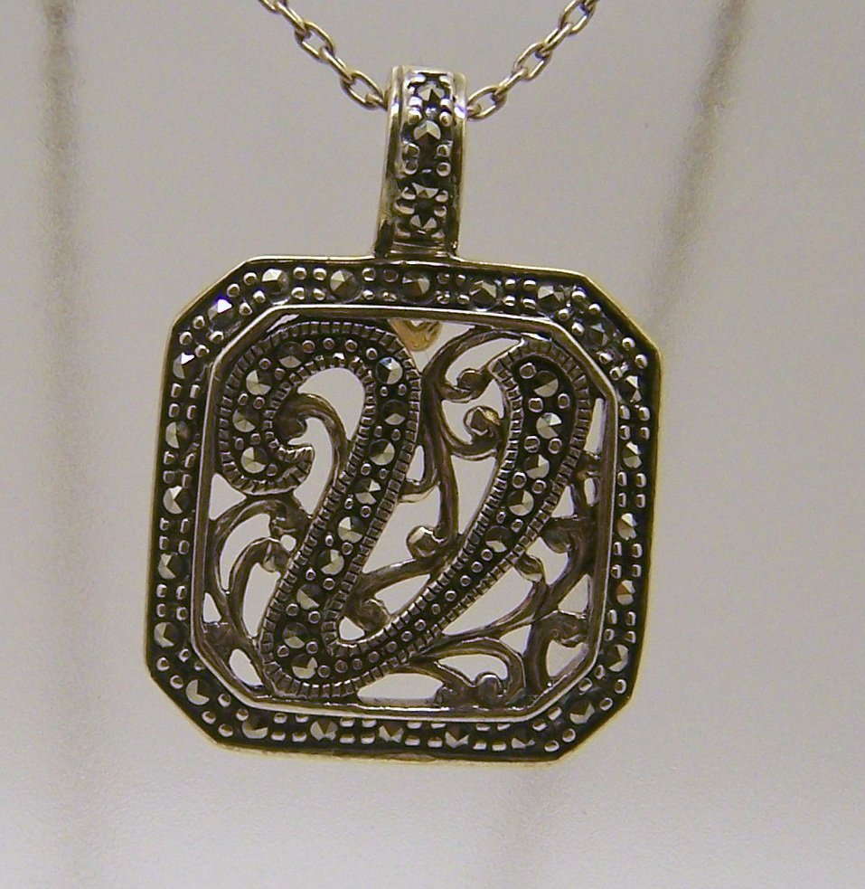 A sterling silver V marcasite pendant: measures 1 5/16" long by 1" wide, weights 7.3 grams, in good condition