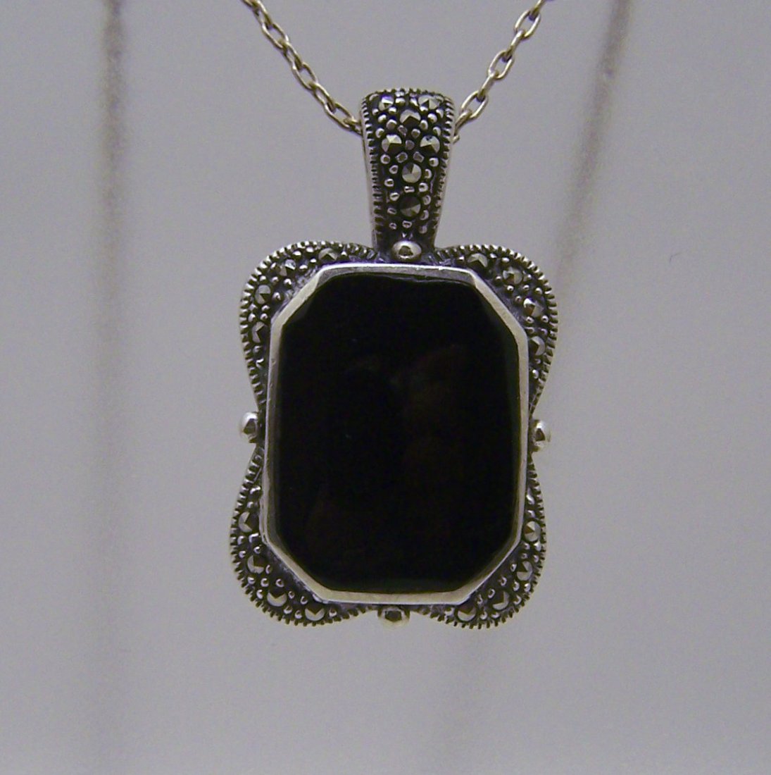 sterling silver onyx marcasite pendant: measures 1 3/8" long by 13/16" wide, weights 7.5 grams, in good condition