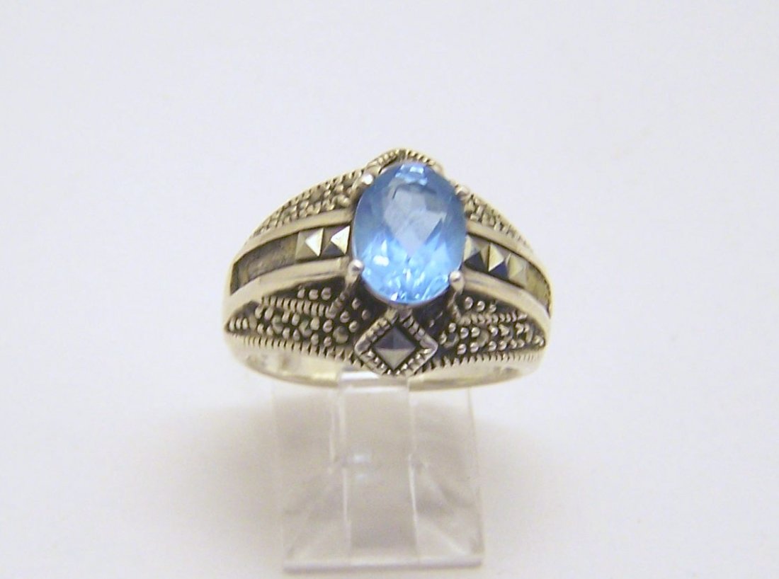 A sterling silver topaz marcasite ring: top of the ring measures 5/8" wide, size 7 1/4 weights 7 grams, in good condition