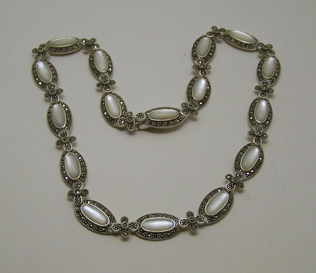 A sterling silver marcasite mother pearl necklace: measures 17" long by 7/16" wide, weights 47.6 grams, in great condition