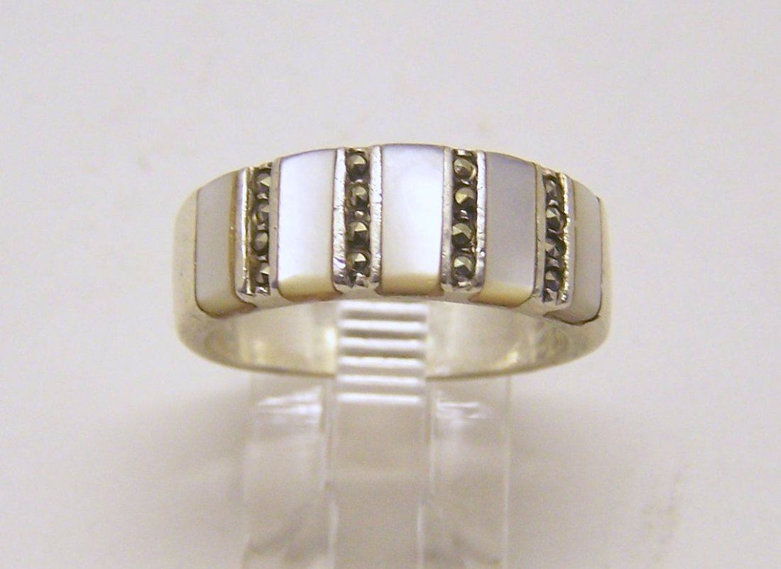 sterling silver mother pearl marcasite ring: top of the ring measures 5/16" wide, size 8, weights 5.9 grams, in good condition