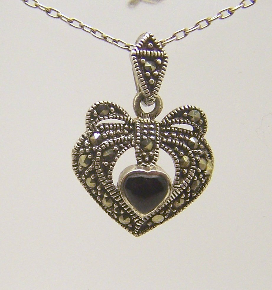 HAN sterling silver marcasite onyx pendant: measures 1 1/8" long by 3/4" wide, weights 3.4 grams, in good condition