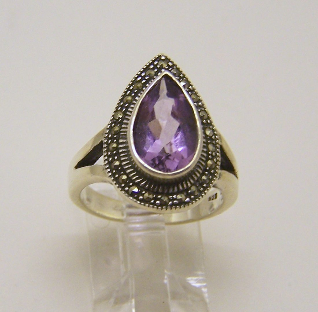 sterling silver marcasite amethyst ring: top of the ring measures 6/8" wide, size 6, weights 4.6 grams, in good condition