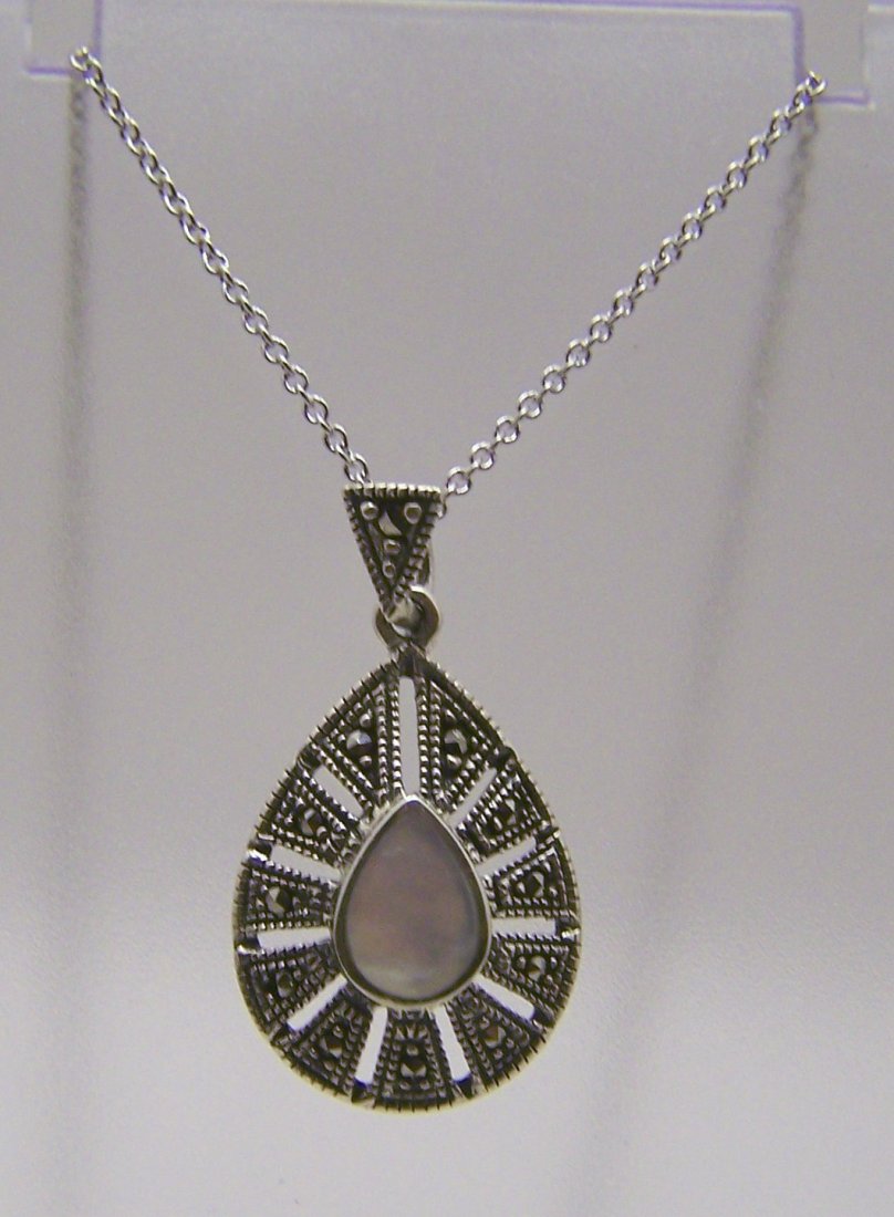A sterling silver mother pearl marcasite necklace: chain measures 18 1/8" long, pendant measures 1 3/16" long, weights 3.8 grams, in good condition