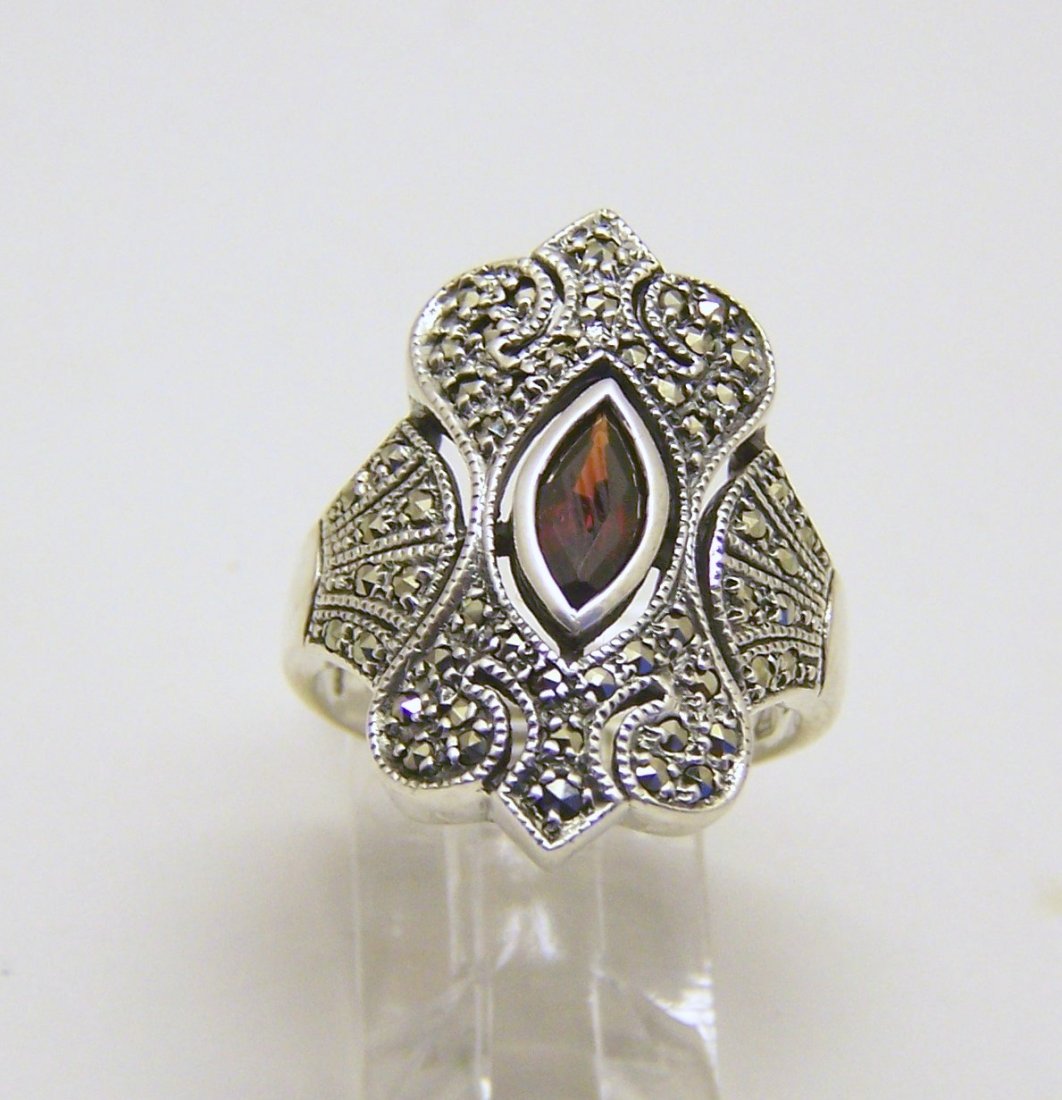 NF sterling silver marcasite blue topaz ring: top of the ring measures 6/8" wide, size 7, weights 7.9 grams, in good condition