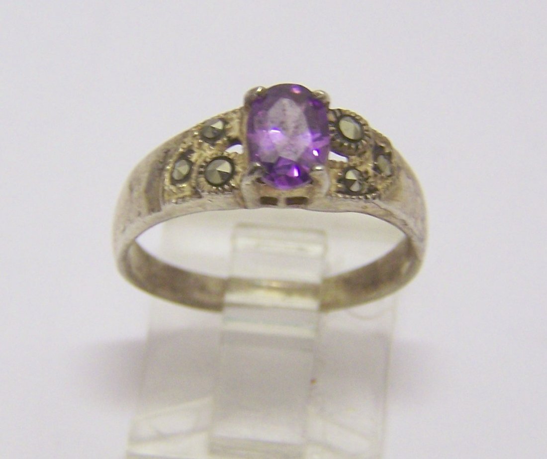 LA sterling silver amethyst marcasite ring: top of the ring measures 1/4" wide, size 7 3/4, weights 2.4 grams, in good condition
