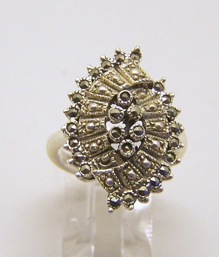 sterling silver marcasite ring: top of the ring measures 1" wide, size 6 3/4, weights 6.5 grams, in good condition