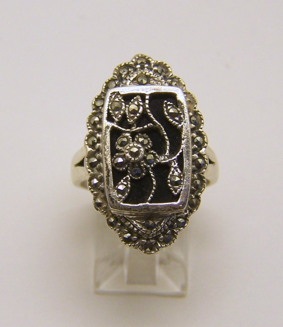 sterling silver marcasite onyx ring: top of the ring measures 1 1/16" wide, size 9, weights 7.6 grams, in good condition