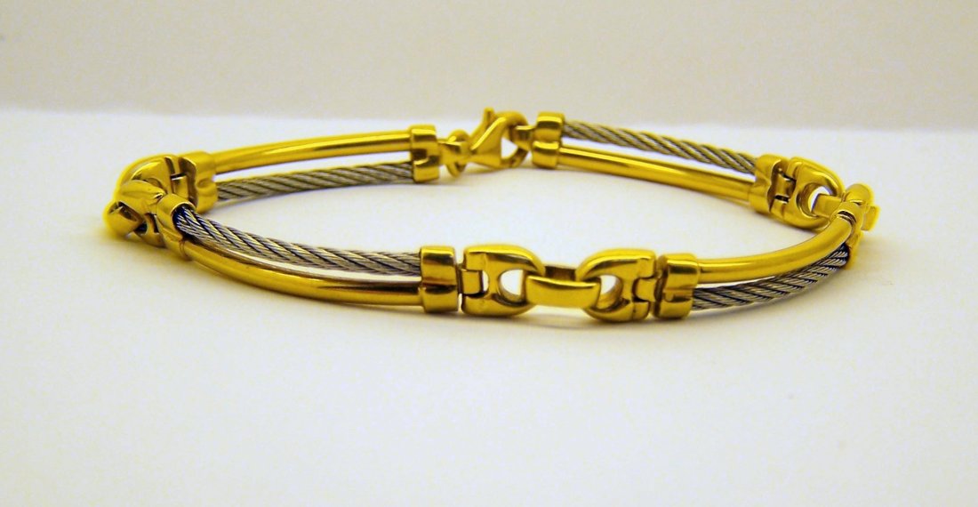 vintage 18k white yellow gold cable bracelet: measures 7 1/4" long by 1/4" wide, weights 16.5 grams, in good condition, not sure if the white cable is stainless steel. looks like a charriol designer