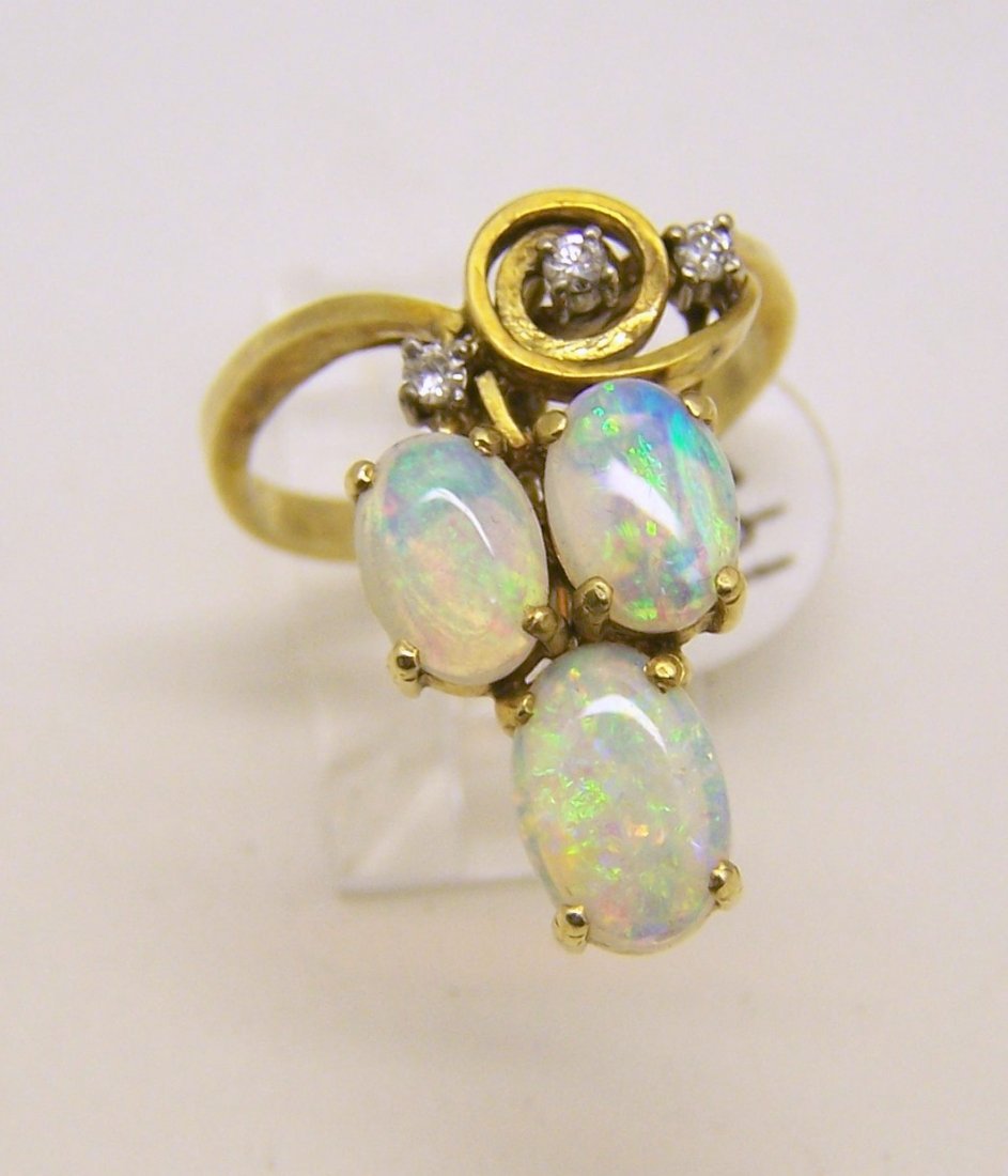 14k gold jelly opal diamond ring: top of the ring measures 15/16" wide, cradted with 7x5mm to 9x6mm opal & 3 of .10ctw VS1 G diamonds, size 6 3/4, weights 4.5 grams, in great condition