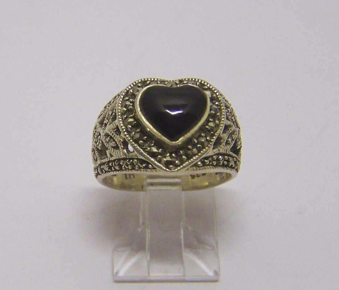 sterling silver onyx marcasite ring: top of the ring measures 1/2" wide, size 5, in good condition