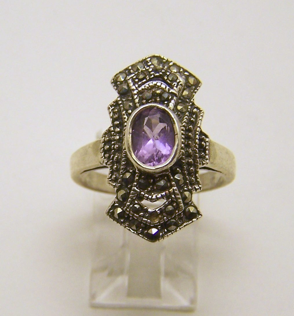 sterling silver amethyst marcasite ring: top of the ring measures 7/8" wide, size 7, weights 4.8 grams, in good condition