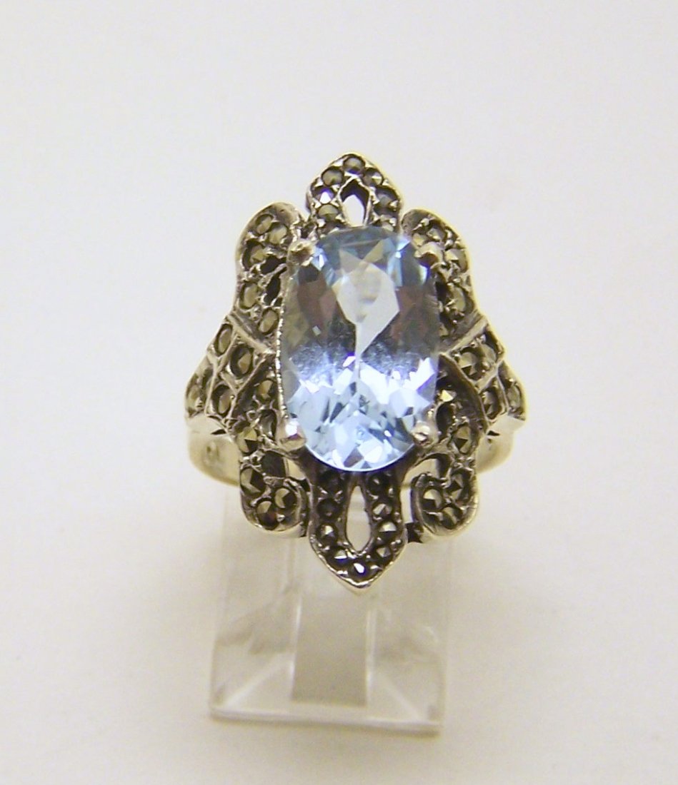 SU sterling silver topaz marcasite ring: top of the ring measures 1" wide, size 6, weights 6 grams, in good condition