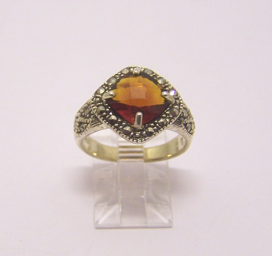 sterling silver marcasite garnet ring: top of the ring measures 9/16" wide, size 7, weights 5.1 grams, in good condition