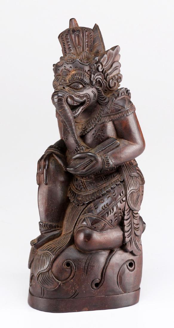 Balinese Carved Wood Deity: Hand carved depicting a Balinese diety in the form of an elephant. H: 11 1/2; W: 4 inches. Shipping weight: 1 3/4 lb.