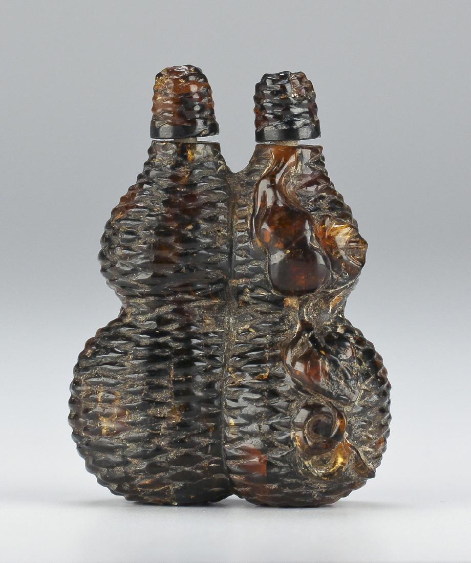Chinese Qing Dynasty Carved Amber Double Snuff Bottle.: Carved amber double snuff bottle with low relief basket weave and stylized flower, caps fitted with bone spoons. H. 3 1//8 Inches.