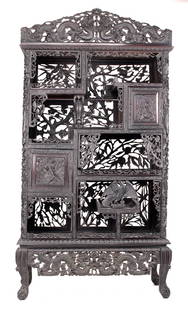 Chinese 19th C. Export Ebony Eteragere: Heavily carved throughout with dragons to crest and apron, center with carved eagle. H: 66, W: 38, Dp: 14 inches.