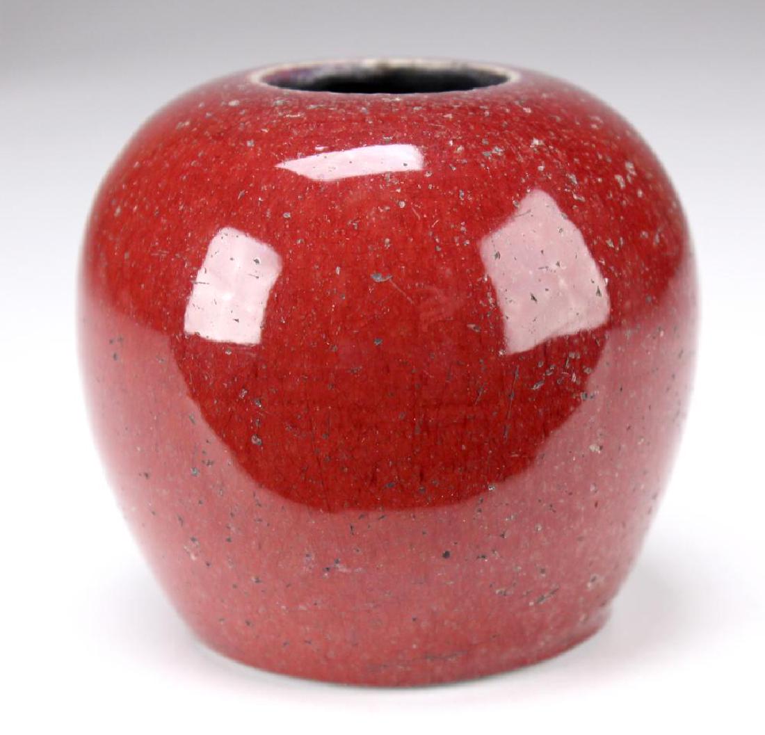 Chinese Qing Dynasty Oxblood Water Coupe: Porcelain low bulbous form, wax seal to bottom, mounted on a carved rosewood base. H: 2.75, Dia: 4.25 inches, with base 3.5 inches. Shipping weight: 1/2 lb.