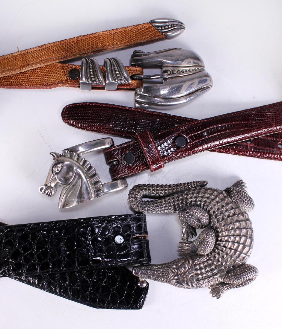 Three Barry Kieselstein-Cord Sterling Buckle Leather: All with sterling silver buckles marked on the reverse: Kieslestein-Cord Sterling. The crocodile buckle: 3 1/4 x 3 1/2; Length: 37 1/4. All belts the same length. Weight: 1 lb. Condition: Good. 