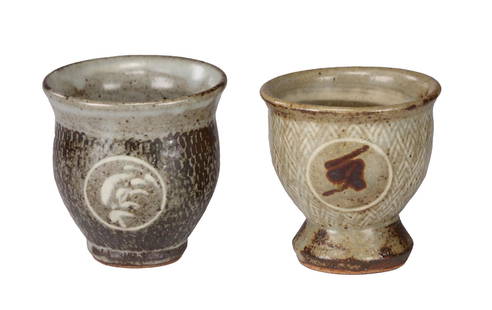 Two Tatsuzo Shimaoka (Japanese 1919-2007) Stoneware: Handmade stoneware pottery, handless, footed teacups featuring rope impressed inlay and slip glaze design (Š—“jomon zogonŠ—) and with a rondel motif with iron oxide overglaze design Tallest: