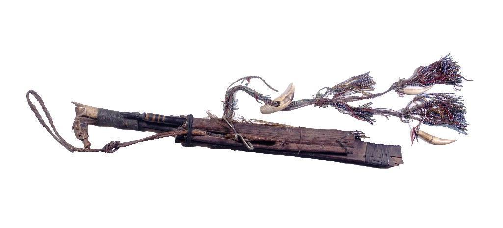Borneo 19th Century Dyak Mandau Head Hunter's Sword: The mandau headhunter's sword (parang thlang) comprised of carved wood scabbard bound with woven rattan and wrapped leather and stands of beads with teeth. The mandau is the traditional weapon o