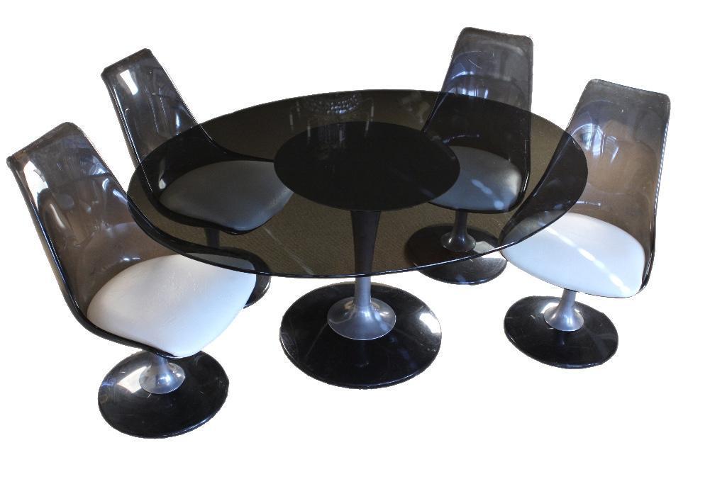 Chromcraft Smoke Lucite Dining Set: Table with smoke glass oval surface on a chrome pedestal base. Four swiveling tulip chairs. H: 29; W: 59 3/4; D: 45 1/2 inches. Chair: H: 34 3/4 inches. Condition: Some scuffing to lucite chairs bases