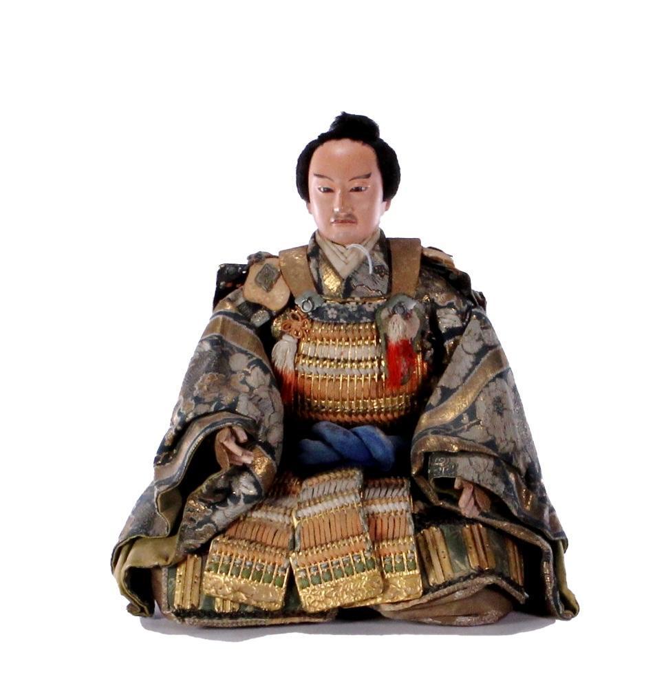 Japanese Musha Ningyo Shogun: A seated warrior doll in traditional armor and kimono. height: 12 1/4 inches. Width: 9 1/2 inches. Weight: 2 1/2 lbs.