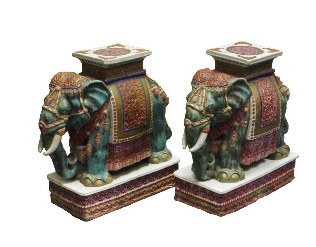 Pair of Chinese 20th C. Ceramic Elephant Form Garden: Pair of large ceramic elephant-form plant stands decorated in traditional dress. Green with red ornamentation. Height: 20 5/8 inches. Length: 21 1/2 inches.