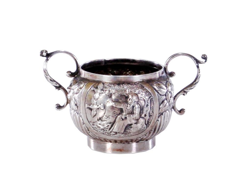 Continental Silver Cup with Biblical Depictions: Illegibly hallmarked silver handled cup with images of Jacob asleep while an angel descends a ladder. The other side with image of Elijah being fed by two ravens Height: 3 inches. Weight: 5 ounces. &n