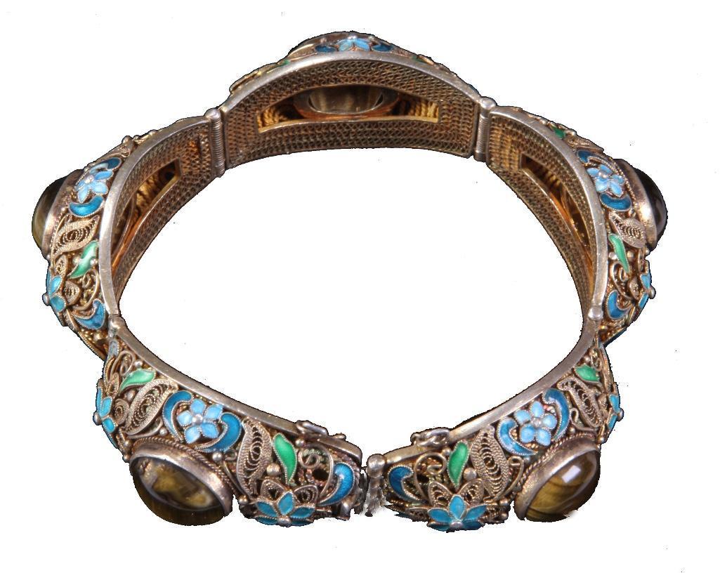 Vintage Chinese Gilt Silver & Tigers Eye Bracelet: The link bracelet with inset tigers eye cabochon and enameled flower decoration. Weight: 3 ounces. Condition: Good. 