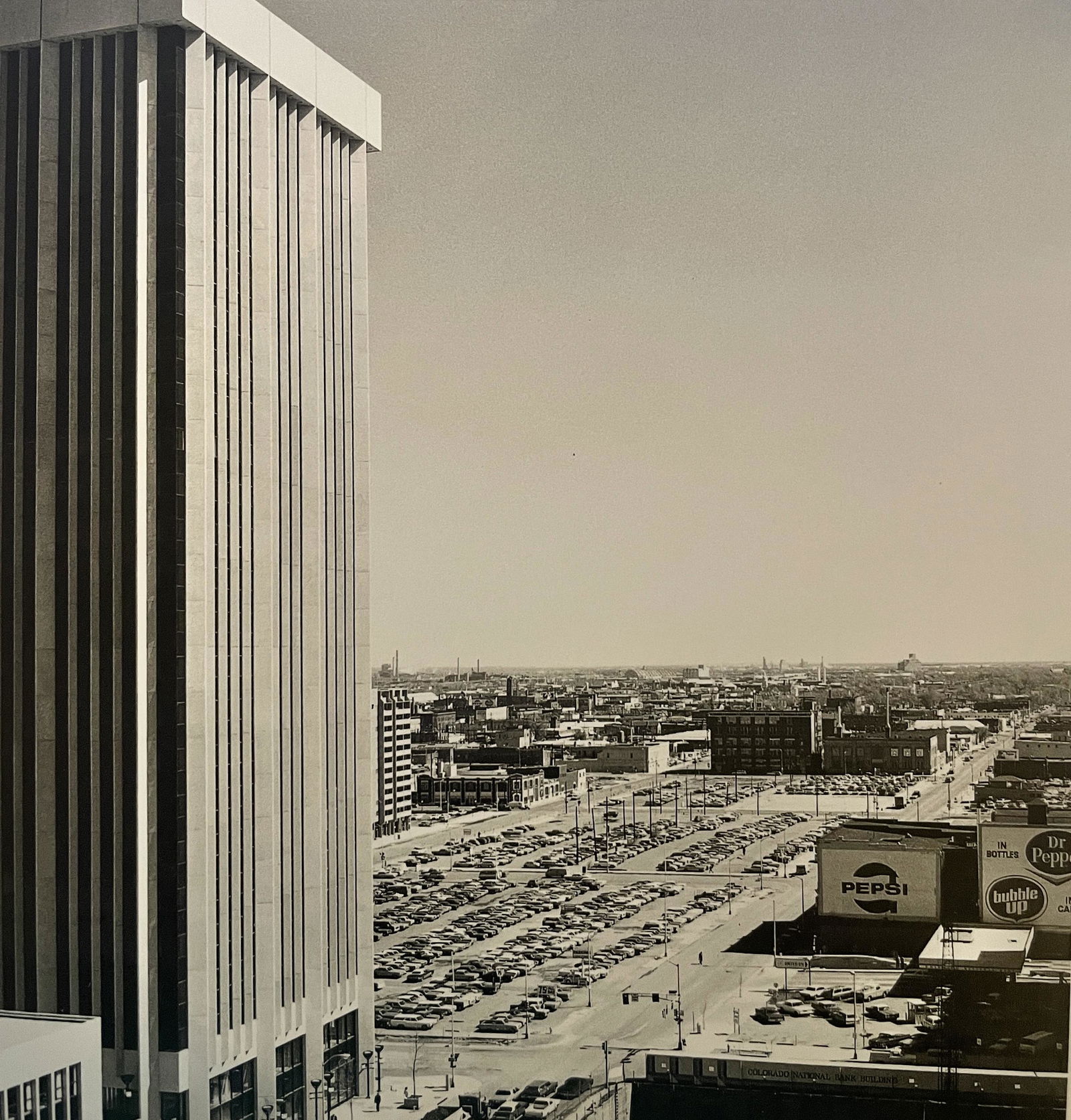 Robert Adams "Curtis Street, Denver" Print: Robert Adams "Curtis Street, Denver" Print. Measures 6.25 x 5.8. Mounted to Archival Quality Paper. Verso is blank. Printed circa 1970's.