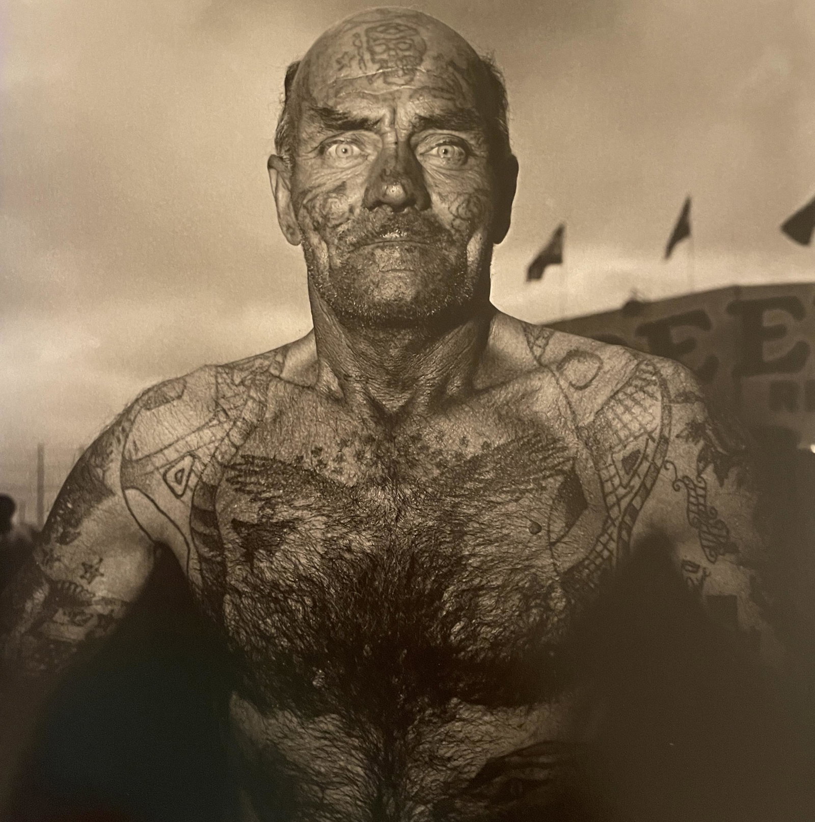 Diane Arbus "Tattooed Man, Carnival, Maryland, 1970" Print: Diane Arbus "Tattooed Man, Carnival, Maryland, 1970" Print. Measures 8.25 x 8.25. Mounted to Archival Quality Paper. Verso is blank. Printed circa 1990's.