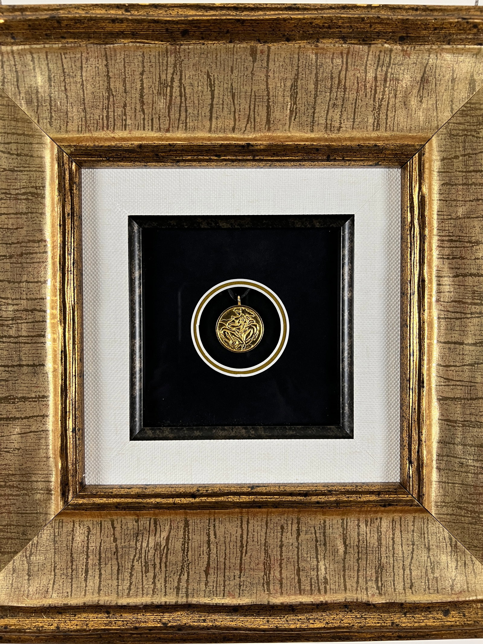 Linda Le Kinff - Framed Two-sided gold plated Cendrillan Pendant with silk cord: Linda Le Kinff - Framed Two-sided gold plated Cendrillan Pendant with silk cord. Signedin the casting. Created in 2004. Pendant Dimensions: 1 x 1 inches. Framed Dimensions 13 x 13 x 2 inches. Framed a