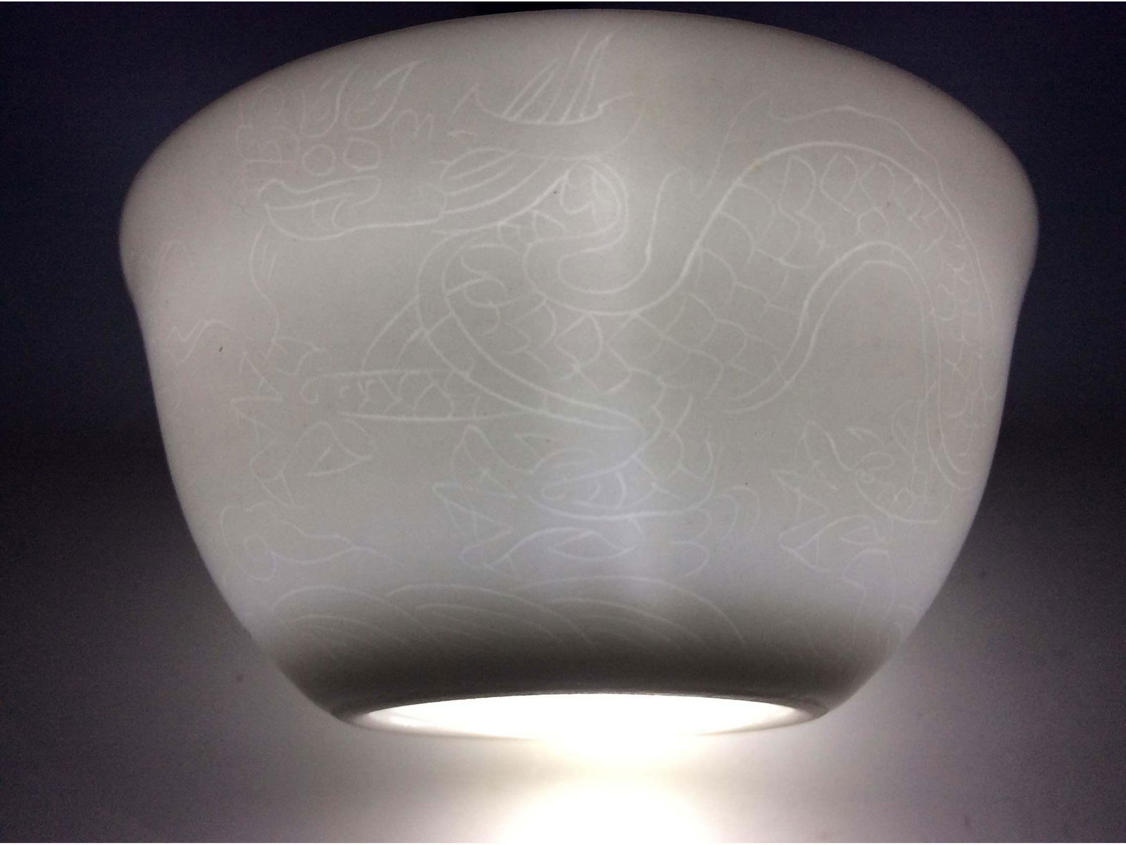 Exquisite Chinese egg shell cup with engraving dragon: Exquisite Chinese white glaze egg shell cup decorated with engraving dragon and phoenix patterns, six-character mark on base. Shipping: We provide in house packing and shipping services at buyer's exp