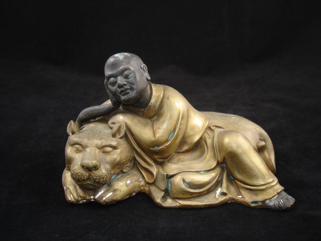 Bronze Antique Chinese Sleeping Arhat/ Luohan with Lion: Bronze Antique Chinese Sleeping Arhat/Luohan with Lion 7 1/4" W X 4 1/2" Ht. Shipping: We provide in house packing and shipping services at buyer's expense. The estimated shipping cost (exclude insura
