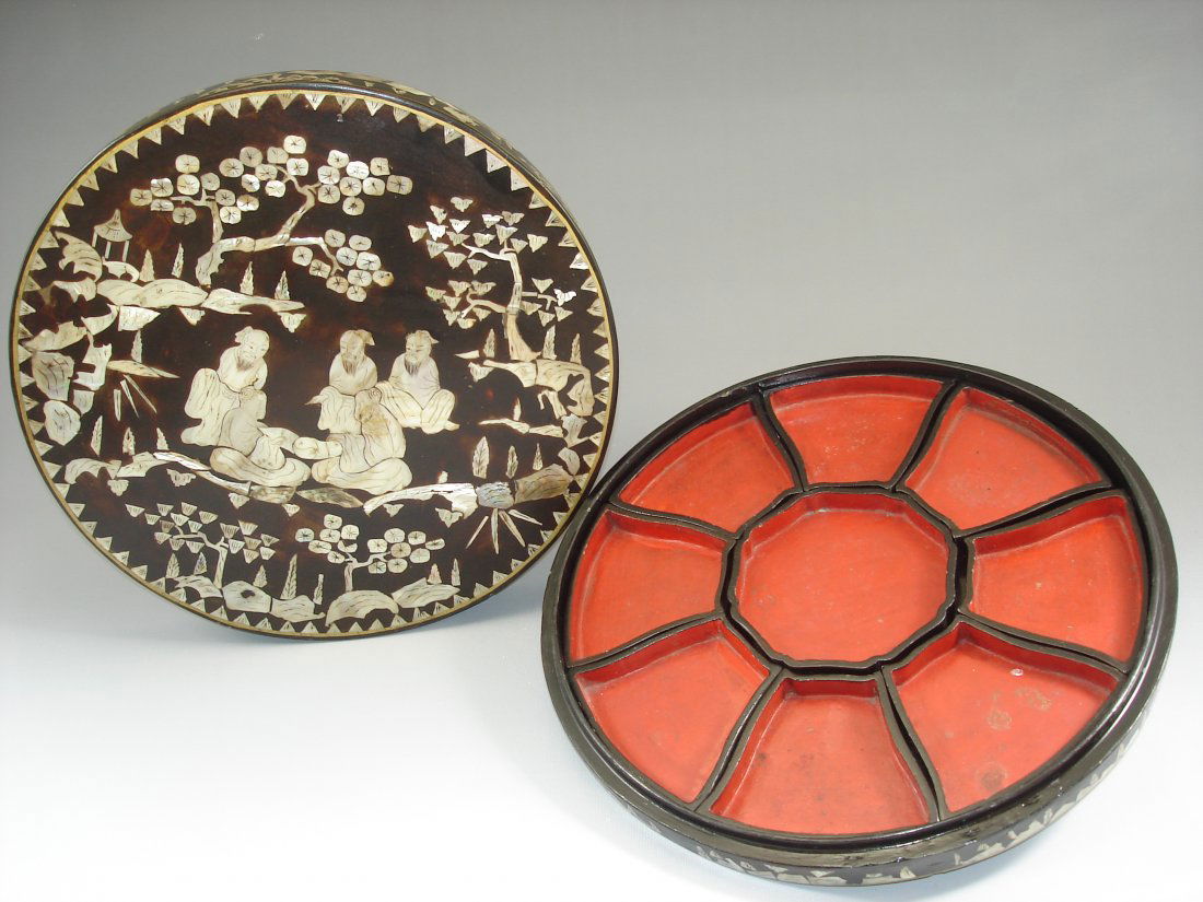 Mother of Pearl Inlaid Round Box With Sectional Server: This is a round box heavily inlaid oriental scenes on the top and sides, interior of box lacquered with nine piece lacquered wood sectional server. SIZE: Approx. 12.75" X 2.4" Shipping: We provide in
