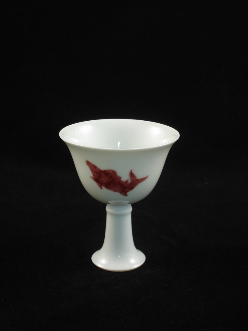 Chinese Red Glaze Stem Cup With Fish Design: An elegant Chinese red glaze stem cup with 3 fish, mark on bottom. 3.25" D X 4" H Provenance: Lot # 191 to Lot # 257 are from a New York private collector whose 30 years of collections. Shipping: We p