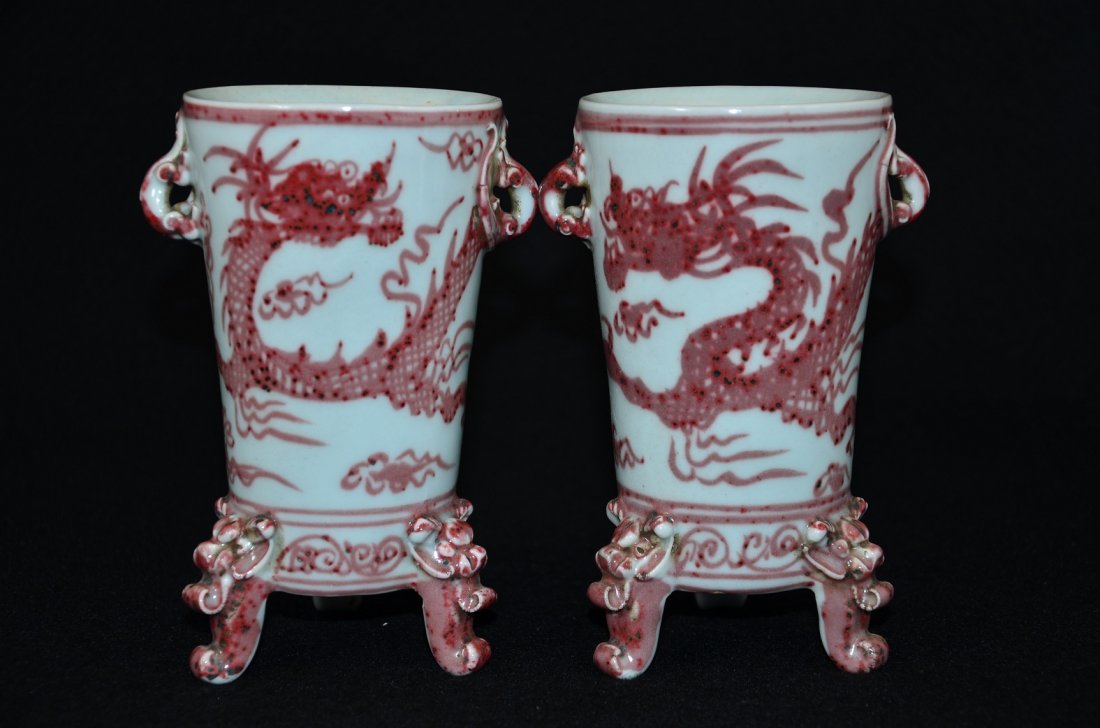 Pair of Mongolia underglazed red vessels/cups: Pair of Mongolia vessels/high cups, painted with under glazed red dragons. Size: 6" Ht. 3 1/2" W Condition: Good condition. (Refer to pictures.) Shipping: We provide in house packing and shipping serv