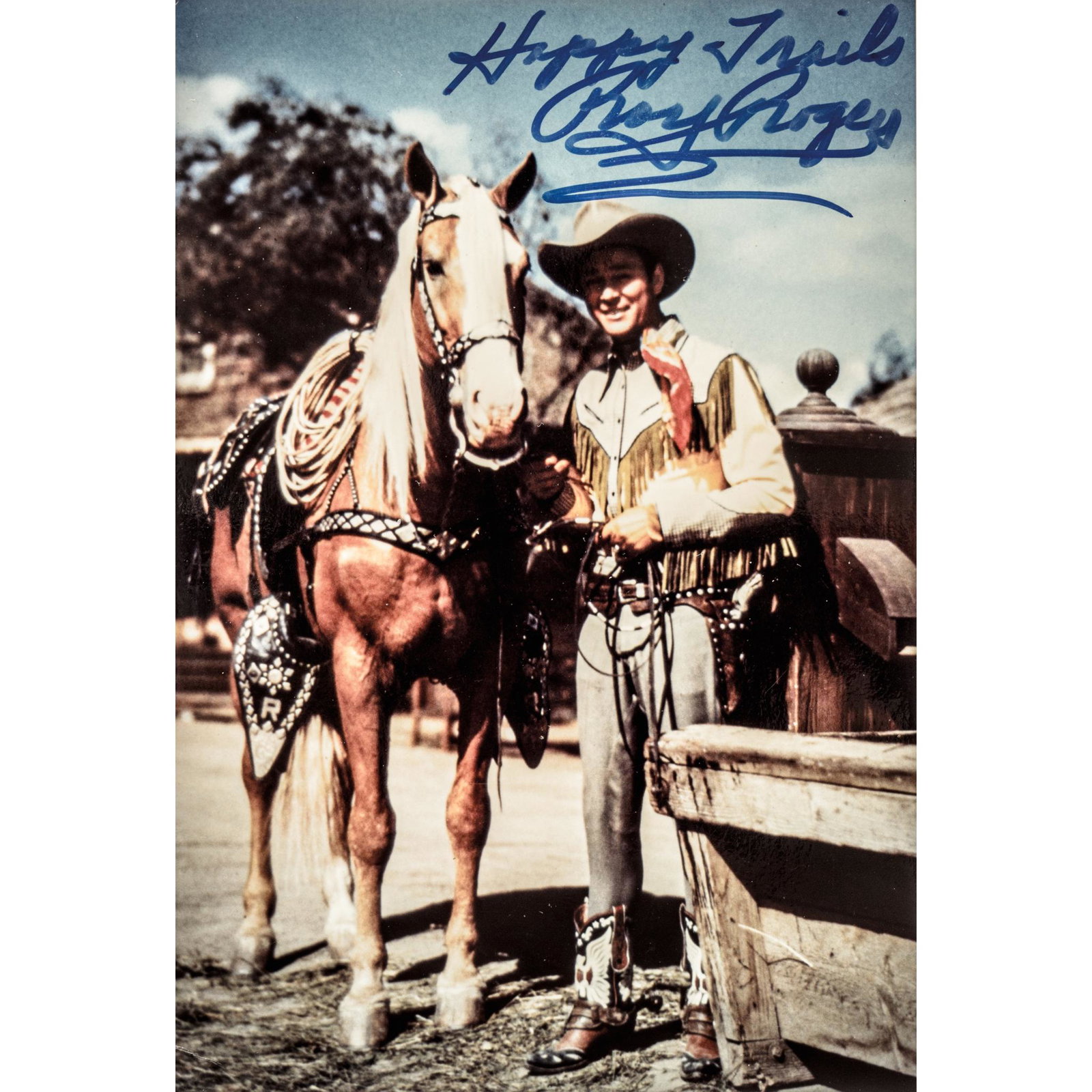 ROY ROGERS +Trigger Autographed Color Photograph: Autographs Autographed Color Photograph of Roy Rogers and Trigger Signed "Happy Trails, Roy Rogers" in Bold Blue Marker ROY ROGERS (1911-1998). Iconic Western Star and Singer, a.k.a. "King of the Cowb