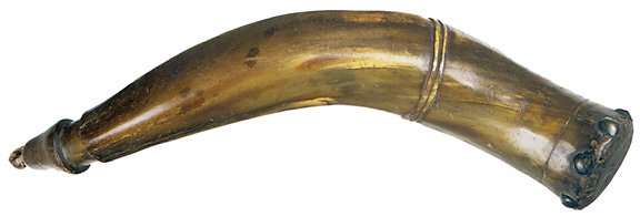 Southern Style Powderhorn-13 Inches: Southern Style Powderhorn, Choice Very Fine. 13" twisted powderhorn, with ochre and brown coloration, carved rings, facets, and wooden base plug held in place by tacks. Original stopper, moderate wear