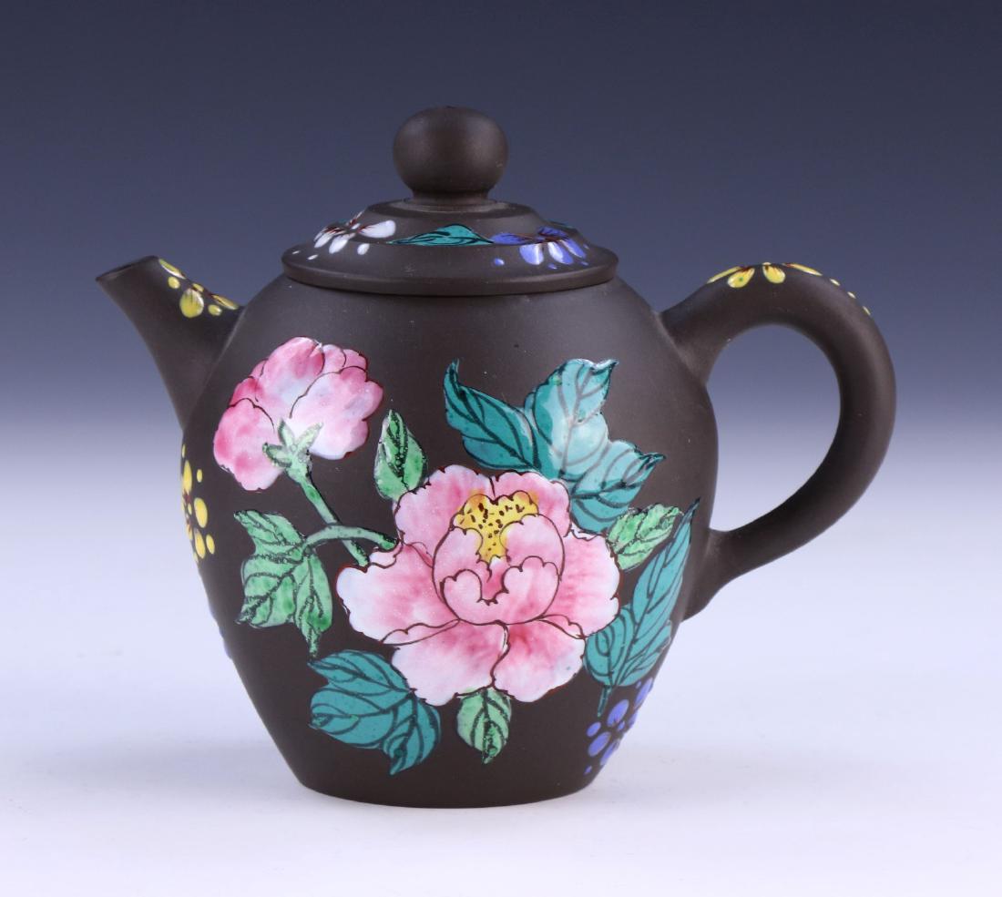 A CHINESE YIXING ZISHA TEAPOT: A Chinese Yixing Zisha Teapot: Of Ovoid Form, Finely Painted With Blooming Flowers Of Mixed Tones Throughout The Body, Domed Lid, Cylindrical Spout, And C-Shaped Handle, Four Character Mark On The Bas
