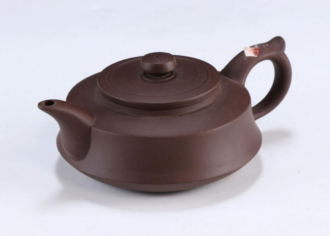 A CHINESE YIXING ZISHA TEAPOT WITH COVER: A Chinese Yixing Zisha Teapot With Cover: Of Compressed Globular Form, With Marks On The Base And Within The Lid; Size: L: 6-1/4" (15.88cm)