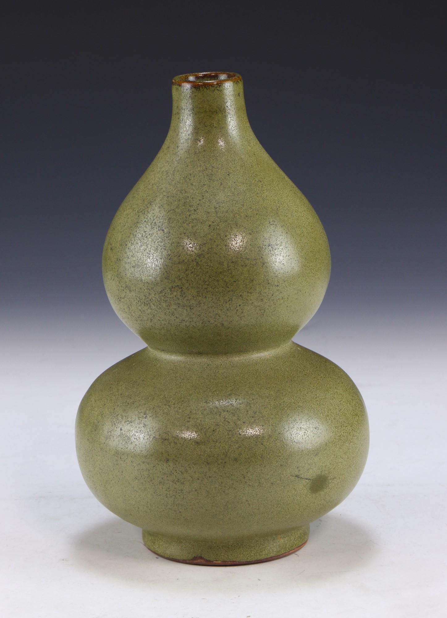 A CHINESE CELADON GLAZED PORCELAIN VASE: A Chinese Celadon Glazed Porcelain Vase: Well Potted And Of Gourd Form, Evenly Glazed in A Light Celadon Tone Throughout; Size: H: 8-1/4" (20.96cm)