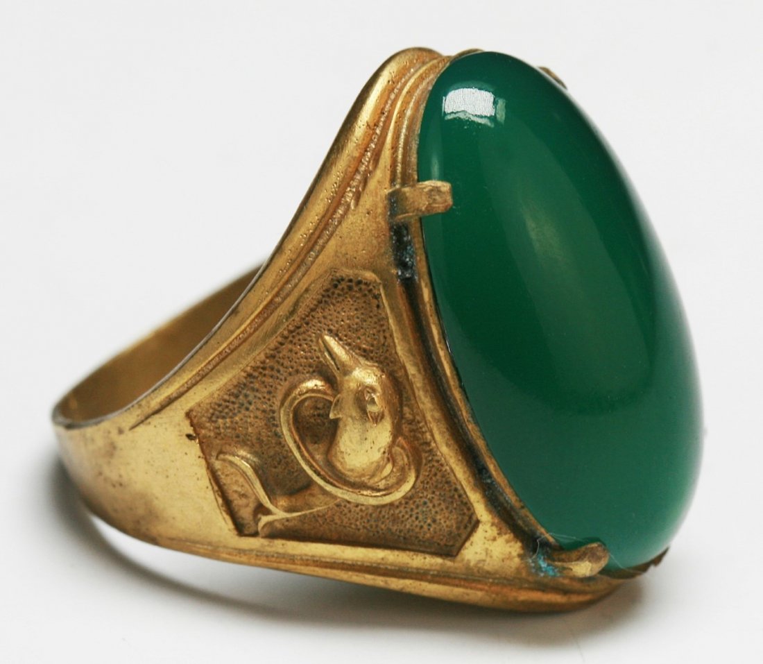 A Highly Translucent Green Jade Or Jadeite Ring: A Highly Translucent Green Jade Or Jadeite Ring: set with a finely polished and carved jade or jadeite of translucent green tone measuring 26mm; Size: Ring Size: 8. 5 (stone) L: 26mm