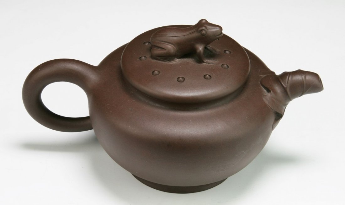 A Chinese Yixing Zisha Teapot: A Chinese Yixing Zisha Teapot: signed on the base; Size: L: 7"